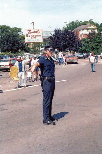 Ptl. Goodwin directing traffic for 4/July/86 parade