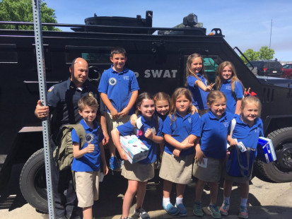 Sgt. Manfredi with kids at Sacred Heart Elementary School